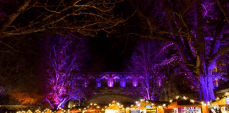 Wooden chalets at Winchester Christmas Market 2025 by the Cathedral