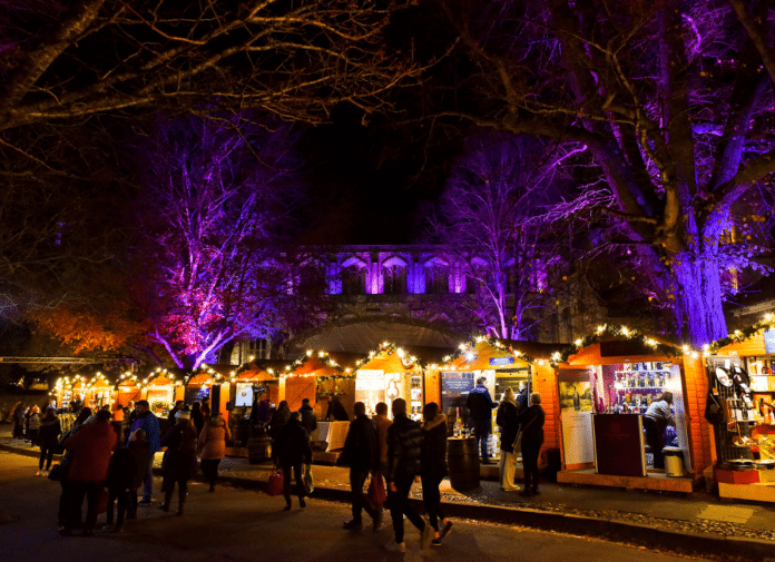 Wooden chalets at Winchester Christmas Market 2025 by the Cathedral