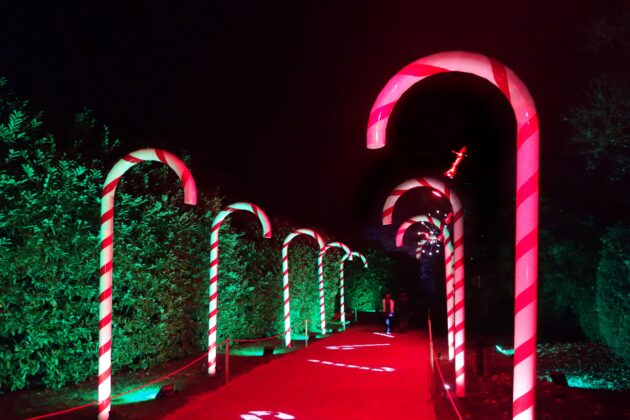 Oversized red‑and‑white candy canes arch over the path at Blenheim