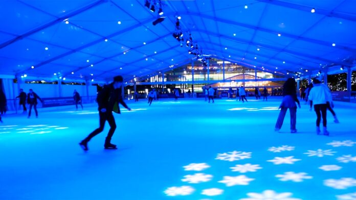 People skating at the ice rink at canary wharf.